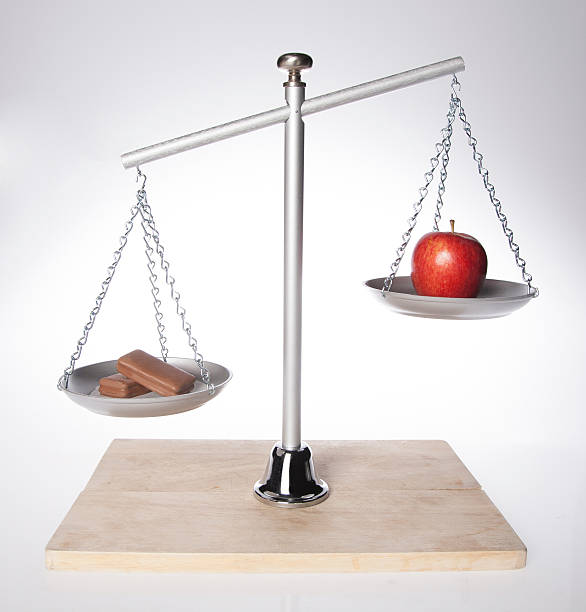 istock Balancing scale healthy apple vs unhealthy chocolate 518981949
