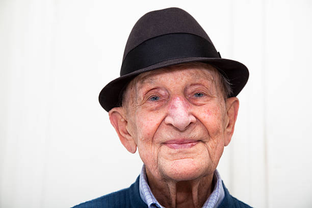 istock Senior male  with quizzical smile wearing a felt hat 518982897