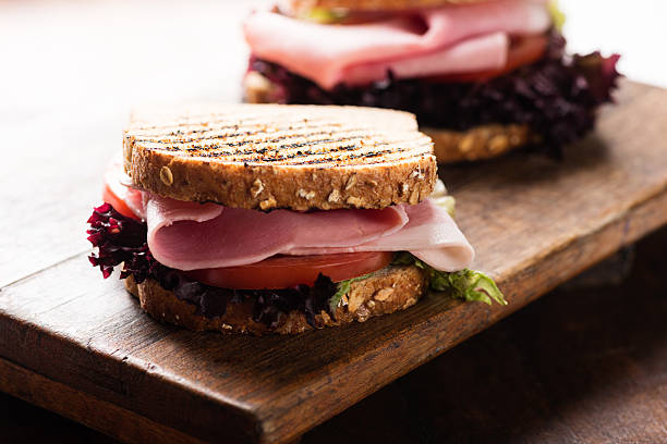 istock Sandwich with ham salad tomato on cutting board 518983051