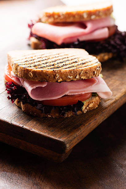 istock Sandwich with ham salad tomato on cutting board macro 518983061