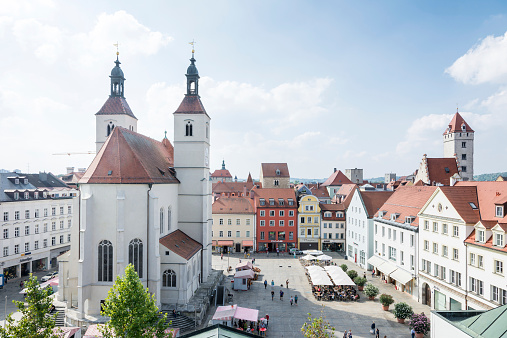 Regensburg, Germany - September 10, 2014:  View over the Neupfarrplatz in Regensburg. Tourists are in the pedestrian area of this town square. Regensburg is a UNESCO world heritage site. Foto taken from Neupfarrplatz with view to the Neupfarrkirche.