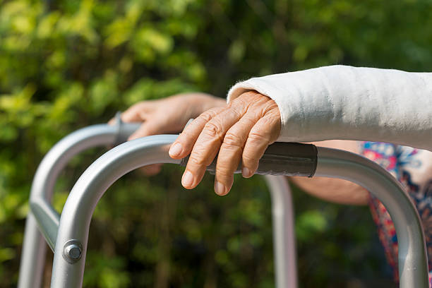 istock senior woman broken wrist using walker in backyard. 519001284