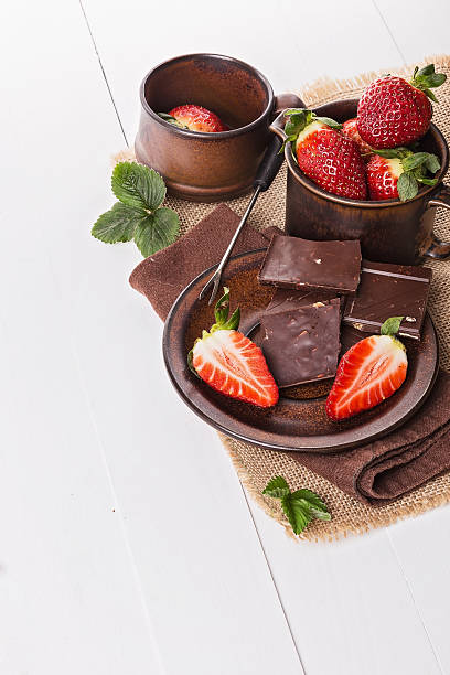 Strawberries and chocolate over white background stock photo