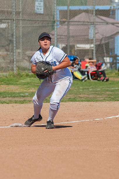 istock Female athlete fielding a ball at 3rd 519002440