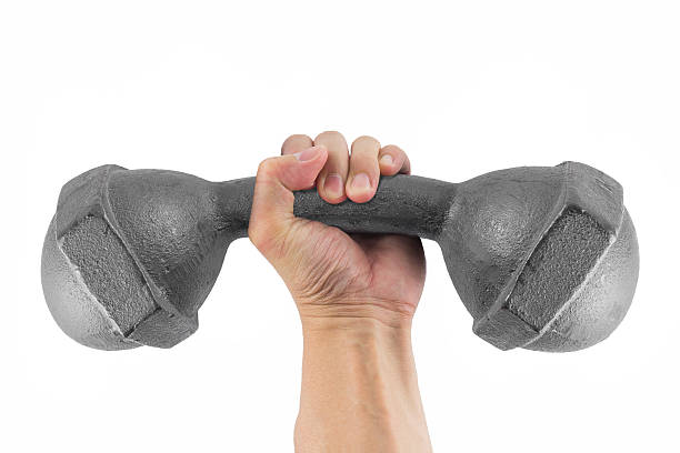 Very heavy concept Hand holding the bending classic dumbbell isolated on white background left handed catcher stock pictures, royalty-free photos & images