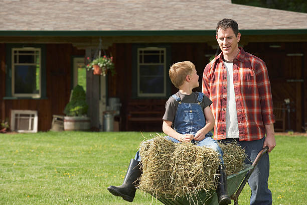 Man pushing wheelbarrow on farm