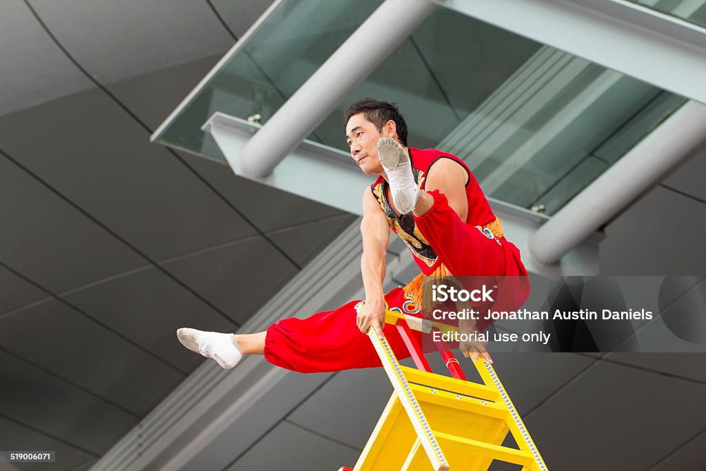 Acrobat Performing Fukuoka, Japan - October 11, 2014: At the 2014 Asia Pacific Festival in Fukuoka, an acrobat performs on a make-shift stage in front of Hakata train station. 2014 Stock Photo