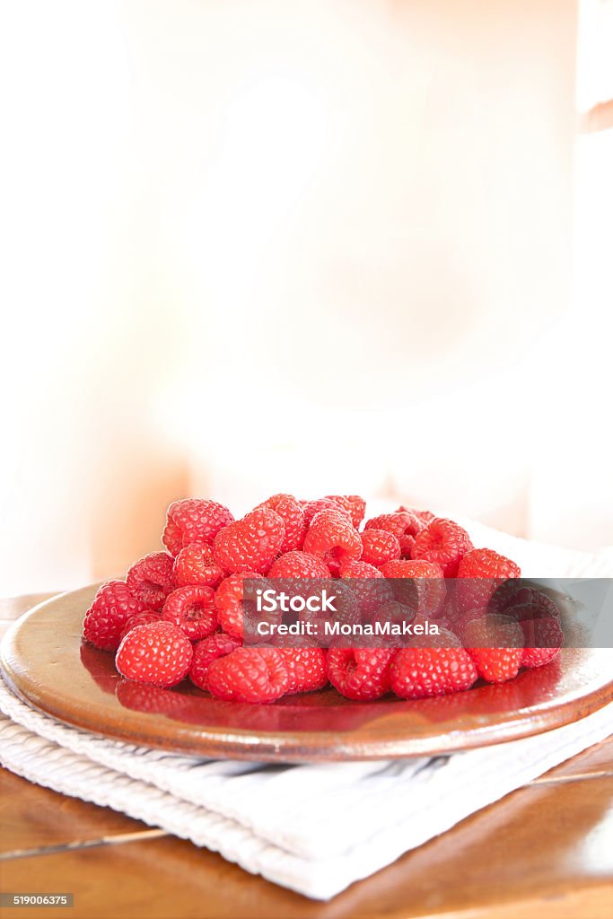 Raspberries Fresh raspberries on a plate with a shallow DOF Berry Fruit Stock Photo