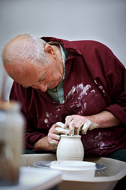istock Potter throwing pot on a pottery wheel 519006779