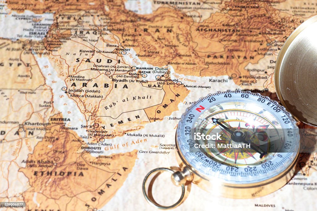 Travel destination Saudi Arabia, ancient map with vintage compass Compass on a map pointing at Saudi Arabia, planning a travel destination Map Stock Photo