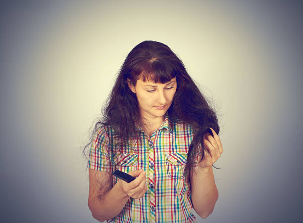 istock young woman looks at her problematic hair 519007802