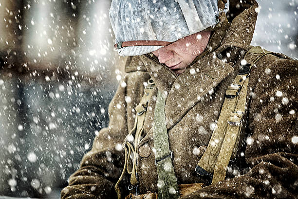 United States Army WWII soldier head bowed in a storming blizzard