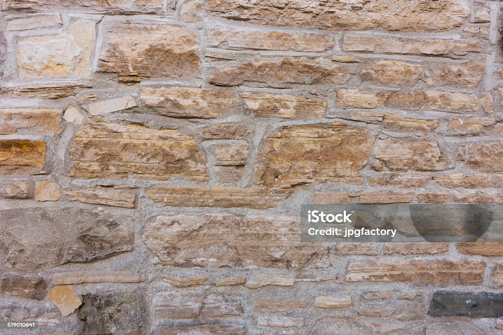 masonry wall ancient stone wall with lines of brick Abstract Stock Photo