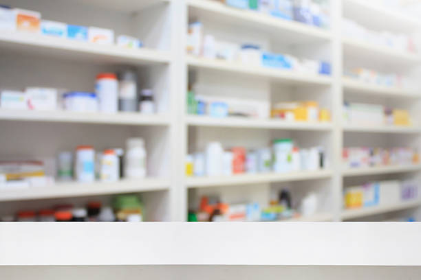 istock pharmacy product display counter with drugstore shelves 519013642