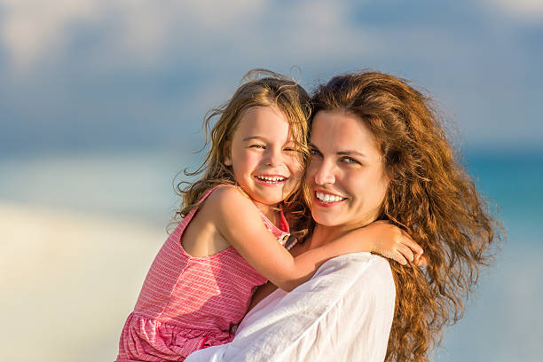 istock Mother and daughter on the beach 519014800