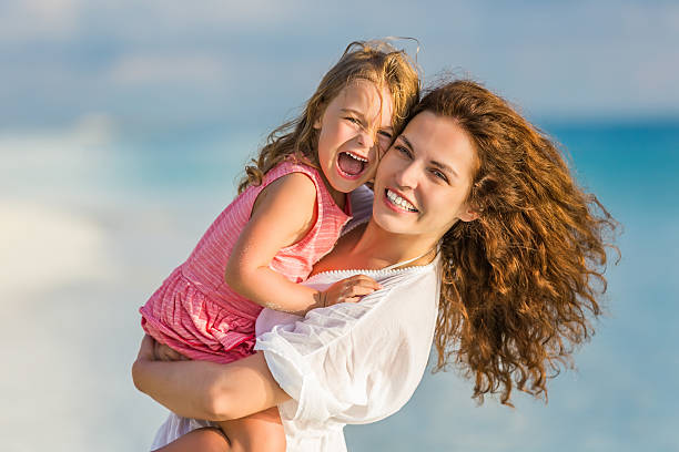 istock Mother and daughter on the beach 519014862