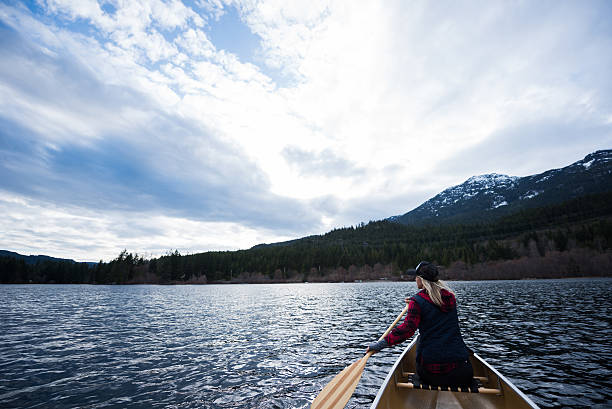 istock Female canoeing on a prisitine lake 519015188