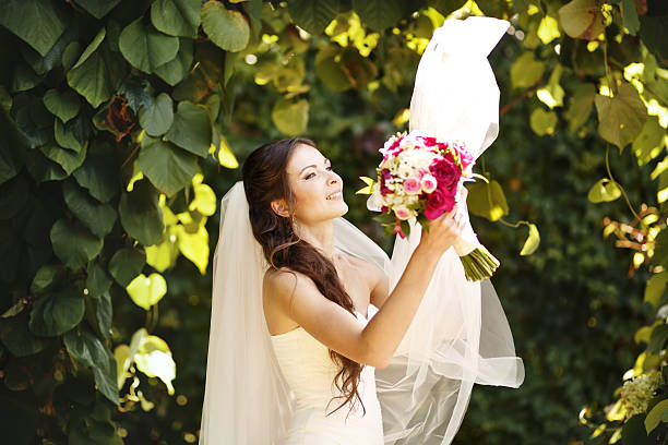 istock Young caucasian bride playing with her veil 519024419
