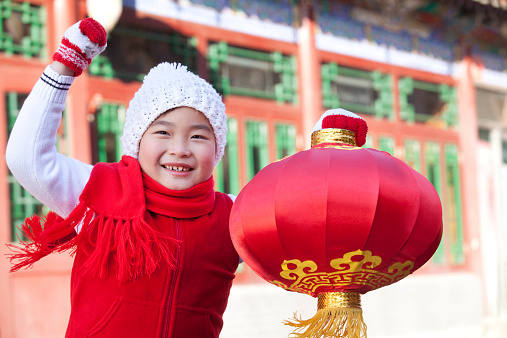Young boy holding red lantern