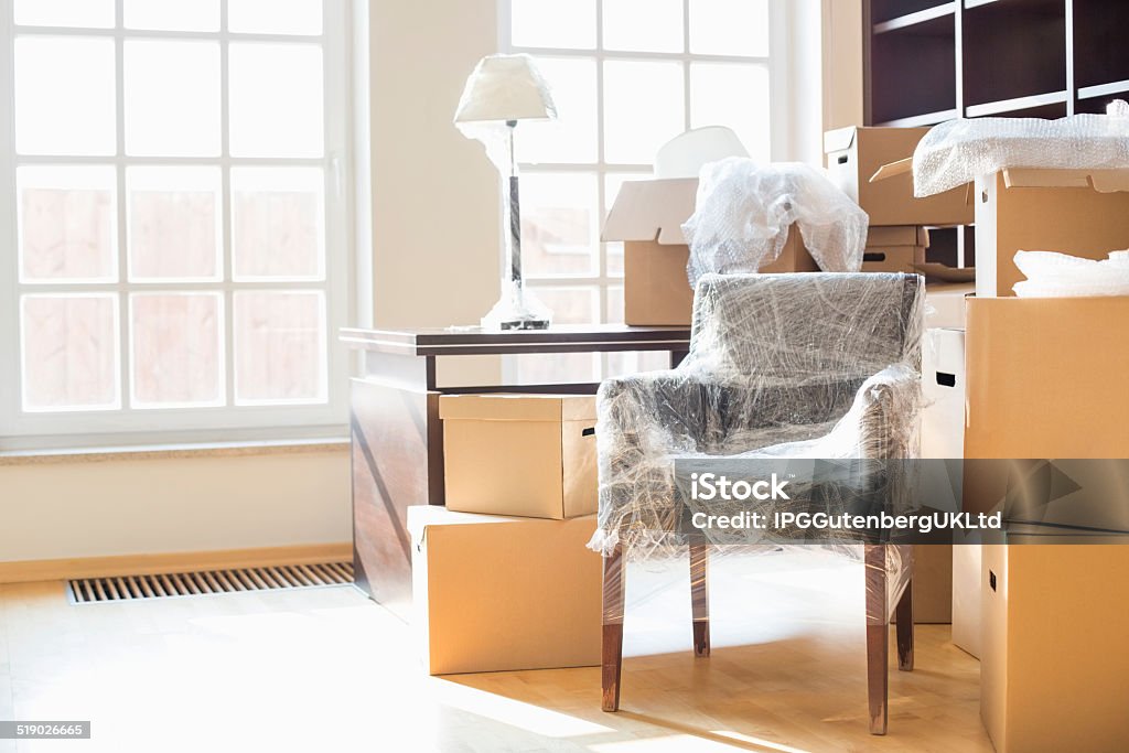 Moving home Moving boxes and furniture in new home Furniture Stock Photo