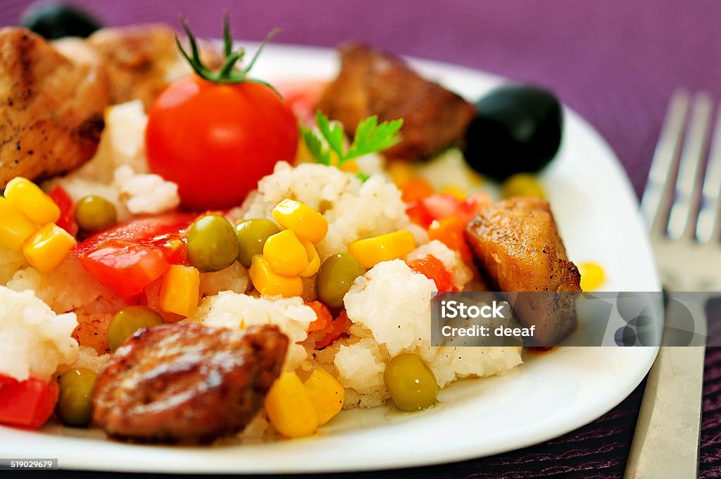 Risotto with meat Plate with risotto and meat Carrot Stock Photo