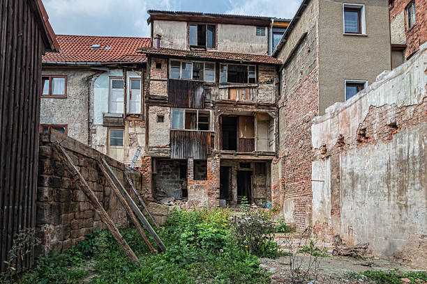 istock facade of a damaged house - ruin 519031115