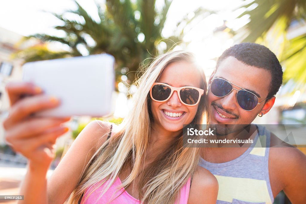 Young Couple Taking Selfie Young couple takes selfie together Adolescence Stock Photo