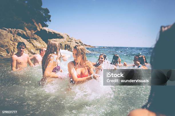 Friends Having Fun In Ocean Stock Photo - Download Image Now - Adolescence, Adult, Beach