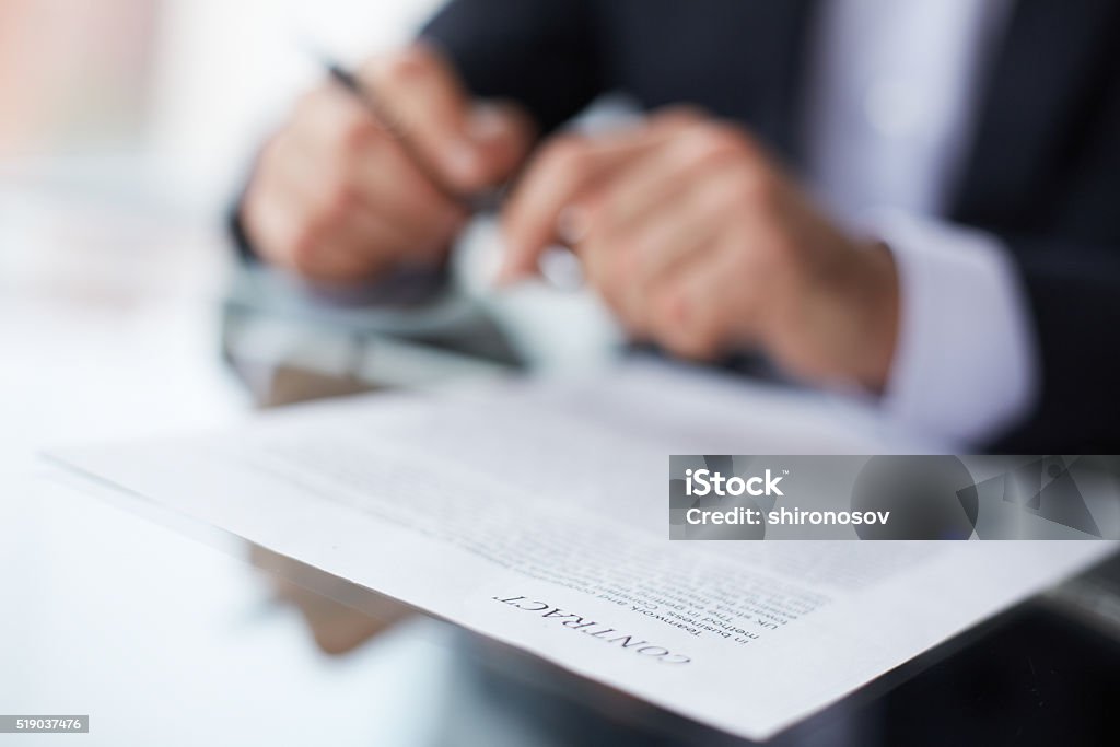 Terms of the contract Shallow dof image of a businessman signing the contract Contract Stock Photo