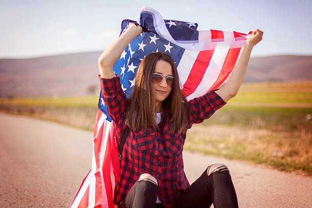 istock Woman holding an American flag 519038652