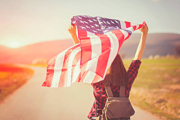 istock Woman holding an American flag 519039136