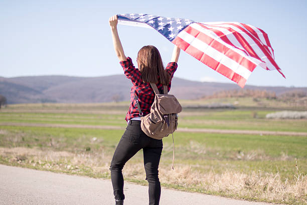 istock Woman holding an American flag 519039396
