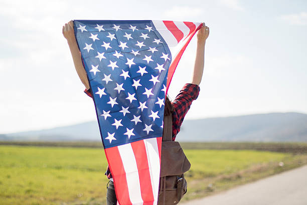 istock Woman holding an American flag 519039646