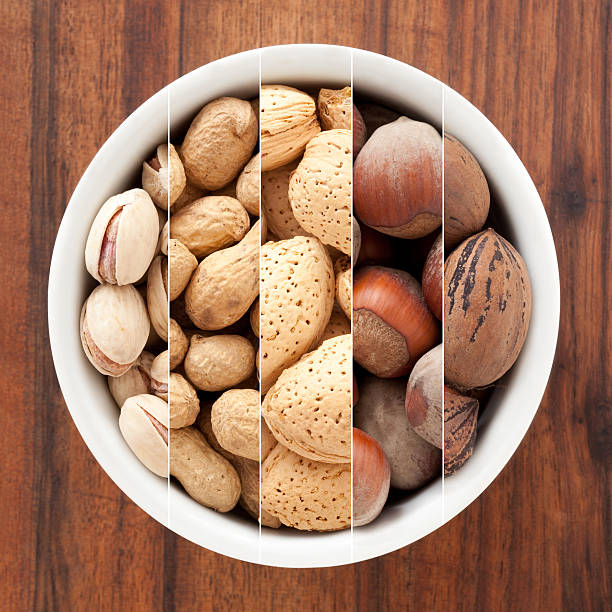 a guscio composizione - peanut bowl nut circle foto e immagini stock