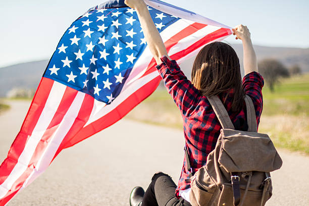 istock Woman holding an American flag 519040350