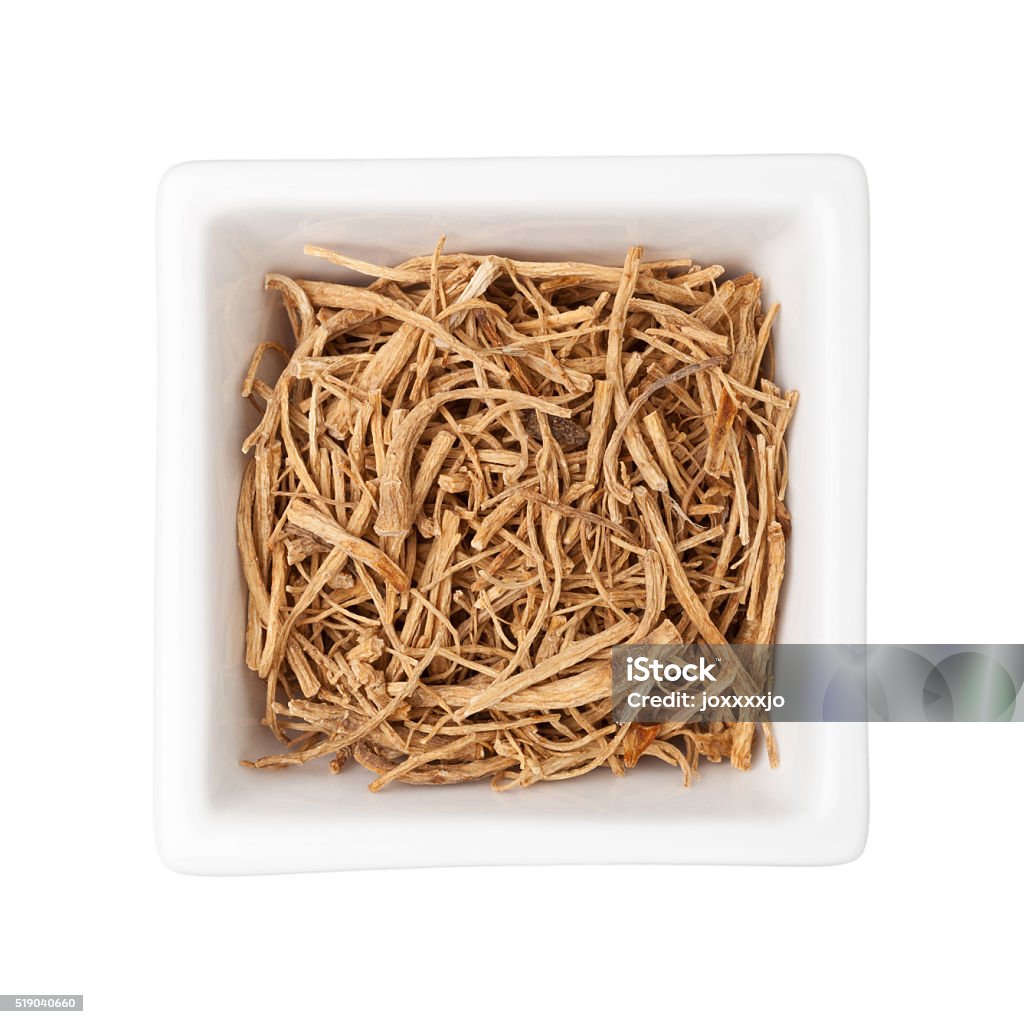 Traditional Chinese Medicine - Ginseng fiber (Panax ginseng) Traditional Chinese Medicine - Ginseng fibers in a square bowl isolated on white background Alternative Therapy Stock Photo