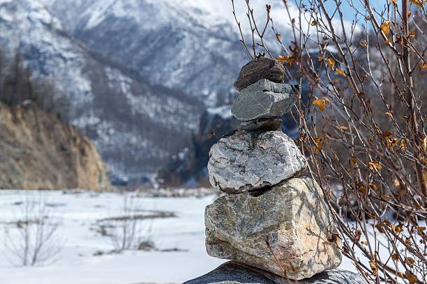 istock Pyramid of stones on a mountains background 519041094