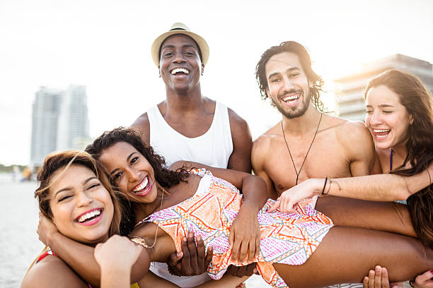 istock friends dancing on the beach for a party 519043028