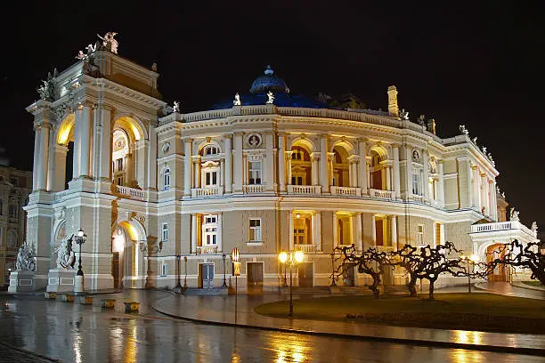The Odessa National Academic Theatre of Opera and Ballet, captured at night, with beautiful night lightning with a lot of reflections on a wet ground.