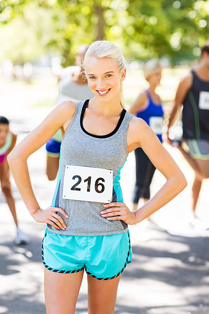 istock Smiling Marathon Runner With Hands On Hips At Park 519047213