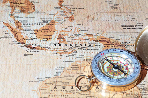 istock Travel destination Indonesia, ancient map with vintage compass 519048039