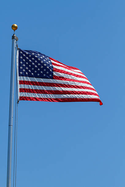istock American Flag Flapping In The Wind On A Clear Day 519048411