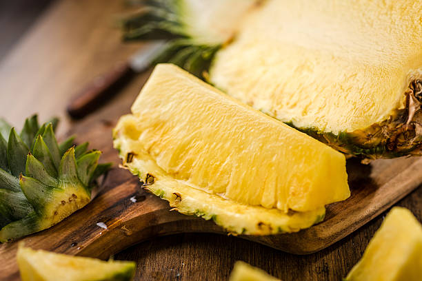 Sliced Pineapple on Chopping Board stock photo