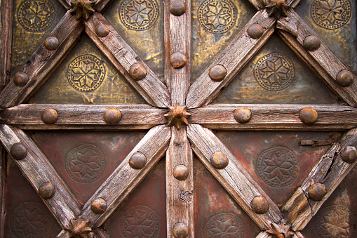 A detail from an ornate 19th-century wooden Indian carved door.