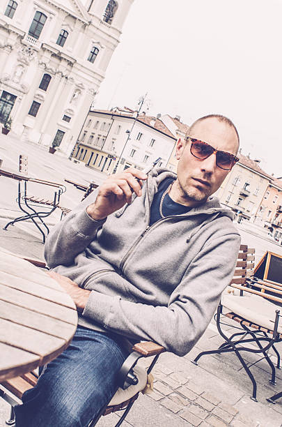 istock Man using electronic cigarette in a bar, Gorizia Italy 519049098