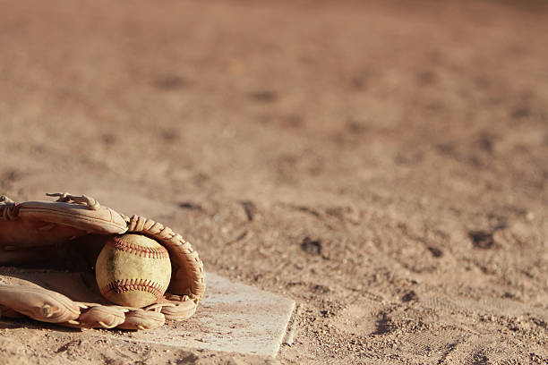 istock Glove and Ball on Home Plate 519049673