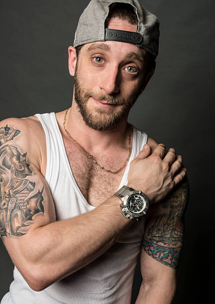istock Male Hip Hop Style Rapper With Tattoos Cap And Beard 519050227