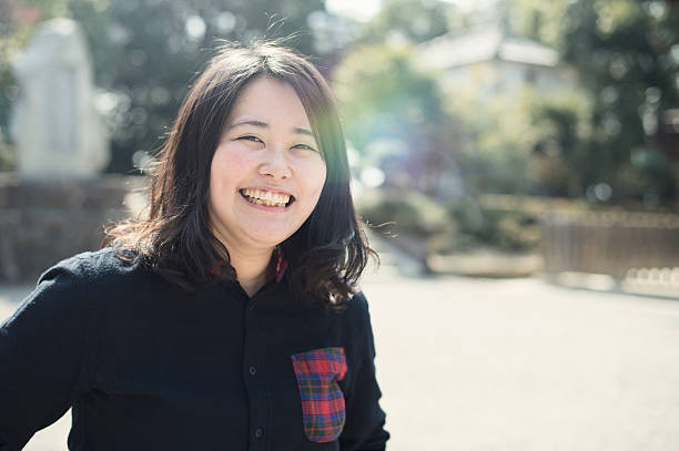 istock Young woman standing with a smile 519050452