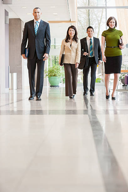 istock Businesspeople walking down a hallway 519050618