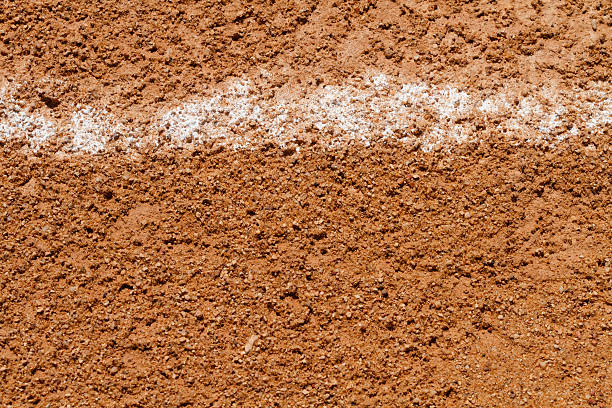 Foul Ball Chalk Line On A Baseball Field A close up shot of a messed up foul ball white chalk line on a little league baseball field at a local public park. chalk outline stock pictures, royalty-free photos & images